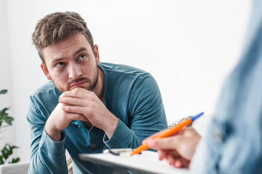 Man sitting and talking to healthcare provider
