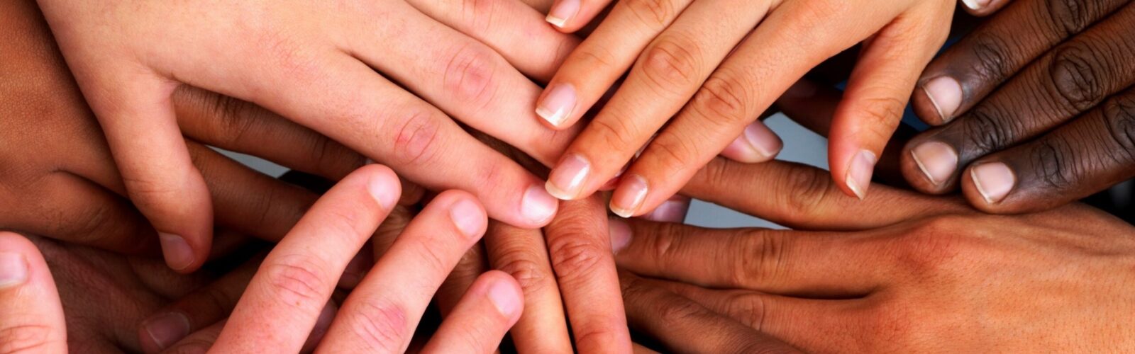 diverse group of hands placed on eachother