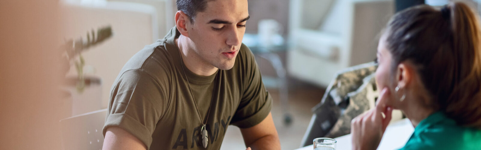 veteran talking to a woman across a desk