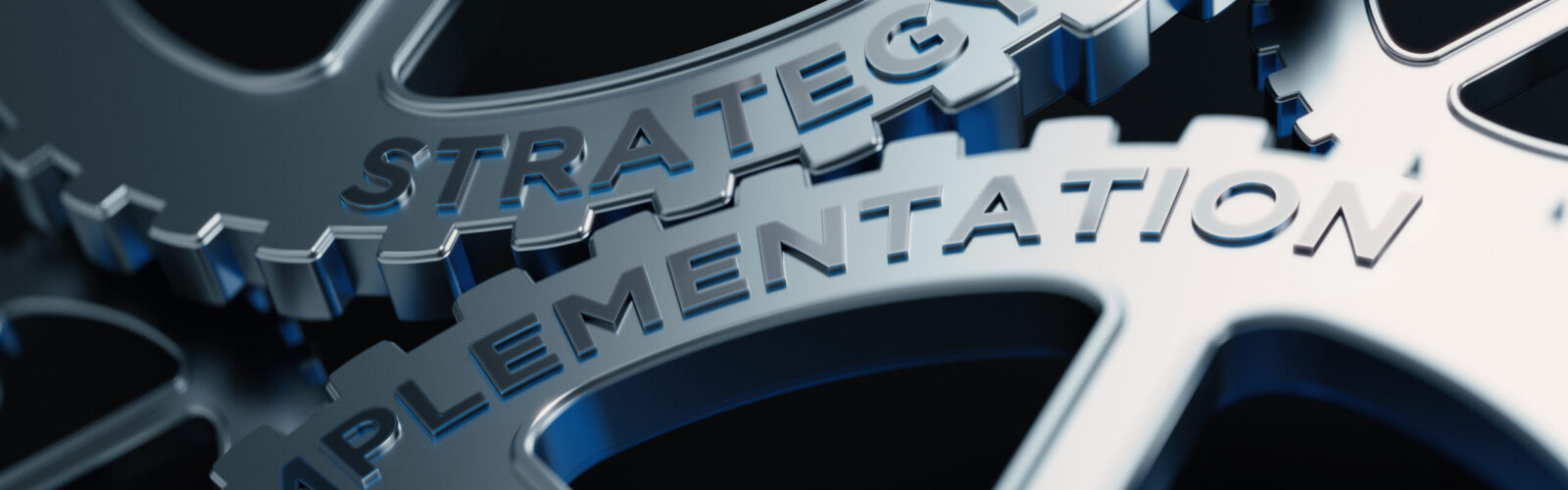 two gears interconnecting with the words strategy and implementation
