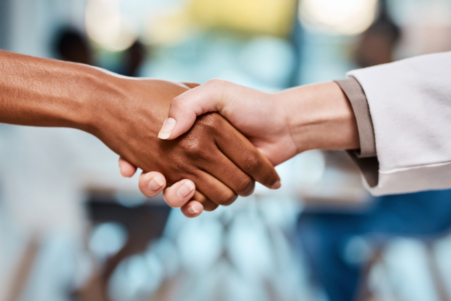 a handshake of two racially different people