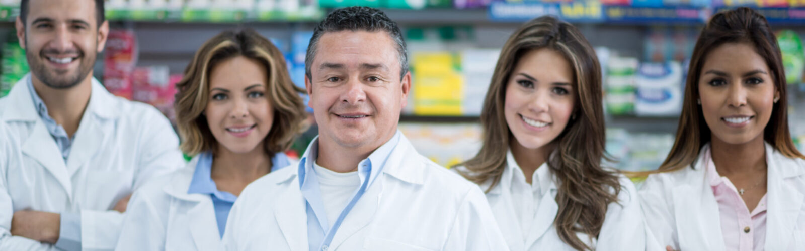 a group of 5 pharmacists in a pharmacy