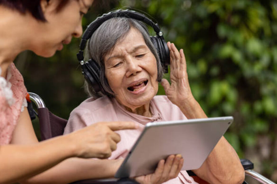 older woman with headphones on