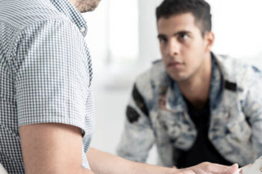 man talking to someone holding a clipboard