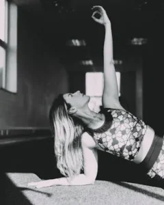 black and white image of a woman holding a yoga move