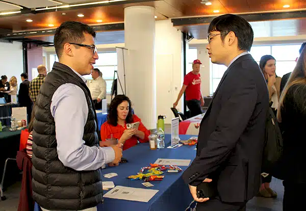 A fourth year pharmacy student chats with a representative at the career fair