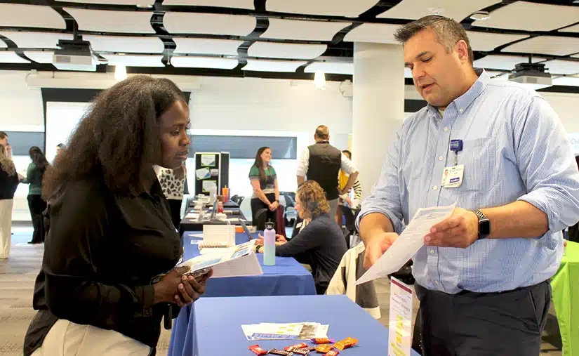 A PharmD student chats with a representative at the career fair