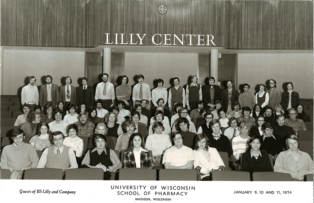Black-and-white group photo in front of a wall with a "Lilly Center" sign