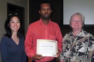 (L to R) Michelle Chui, associate professor, Social and Administrative Sciences Division; Ephrem Aboneh, graduate student; Dean Jeanette Roberts.