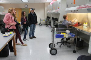 Joshua Nachreiner, DPH-2, (right) demonstrates a procedure in the sterile compounding lab.