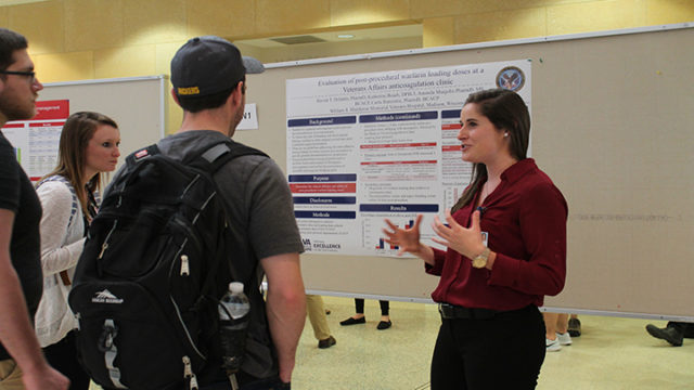 Katherine Beach, DPH-3. (right) shares her research at the annual symposium.