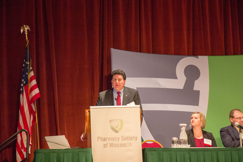 Rocky LaDien speaking at podium for Pharmacy Society of Wisconsin