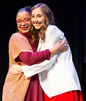 A PharmD student gets a hug from alumna Yolanda Tolson