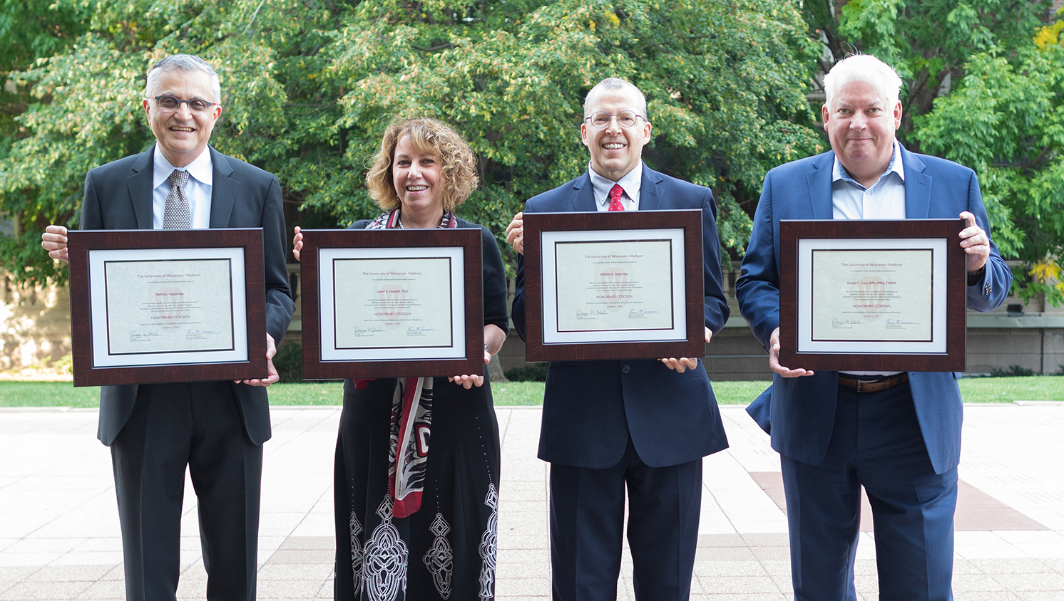 Citation of Merit recipients standing in a line holding up their awards