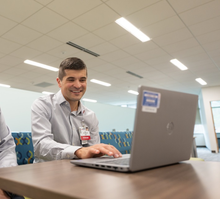 Peter Kleinschmidt, a physician at UW Health, works at his computer.