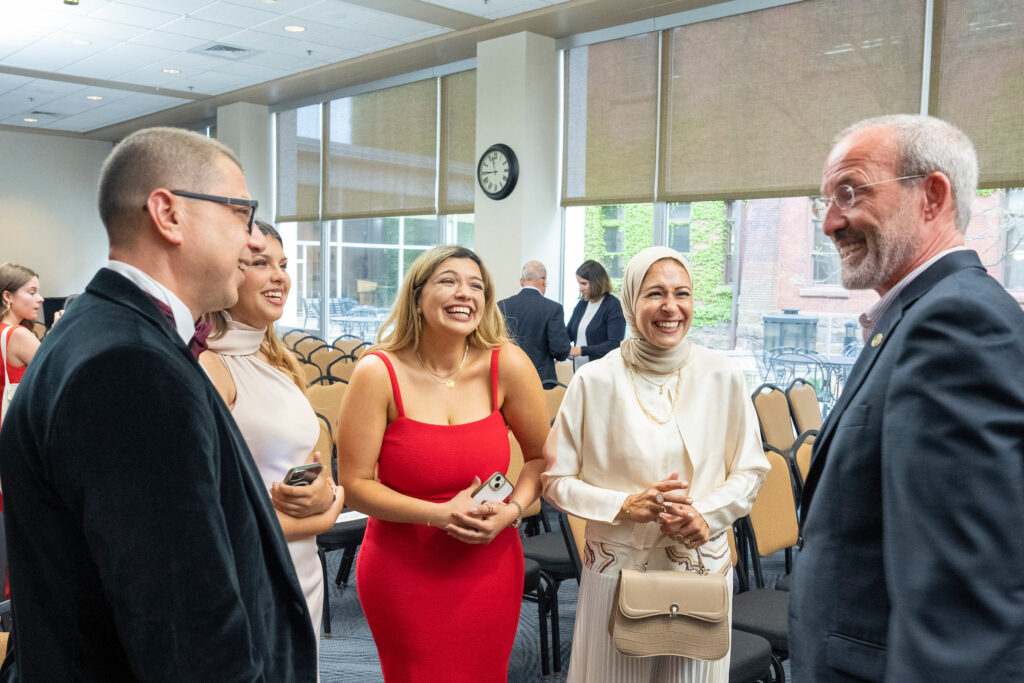 A graduate and her family speak with Dave Mott.