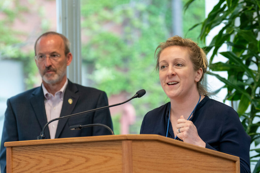 Sharon Faust speaks at the podium.