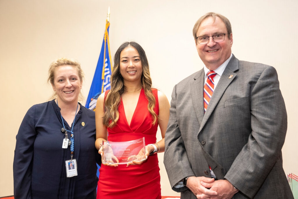 Ziting Zhang poses with Dean Swanson and Sharon Faust.