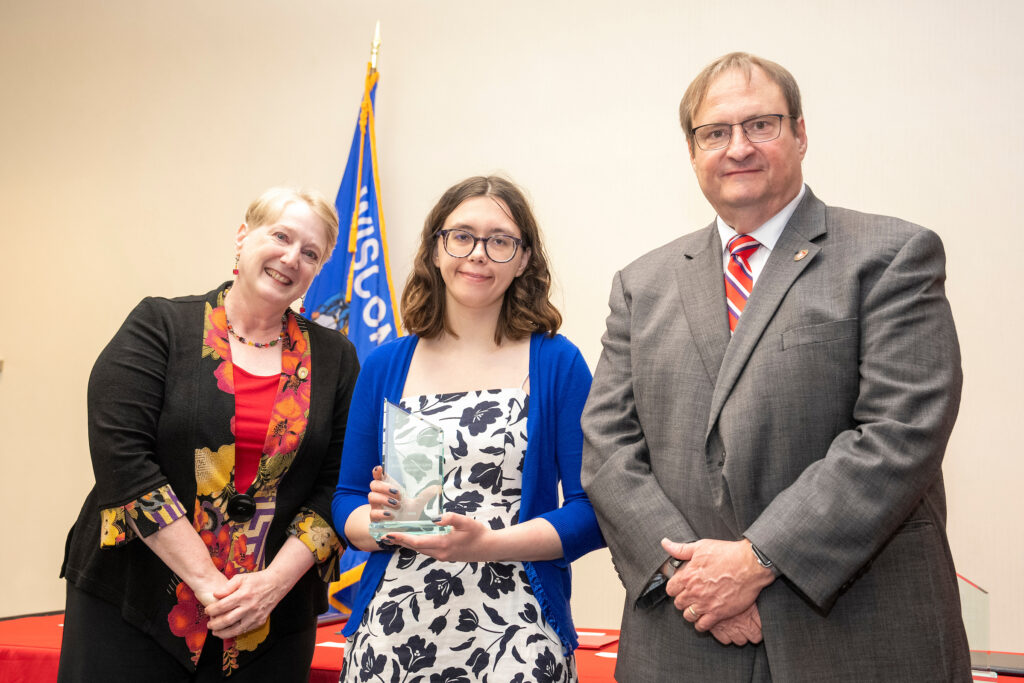 An award-winner poses with Karen Kopacek and Dean Steve Swanson