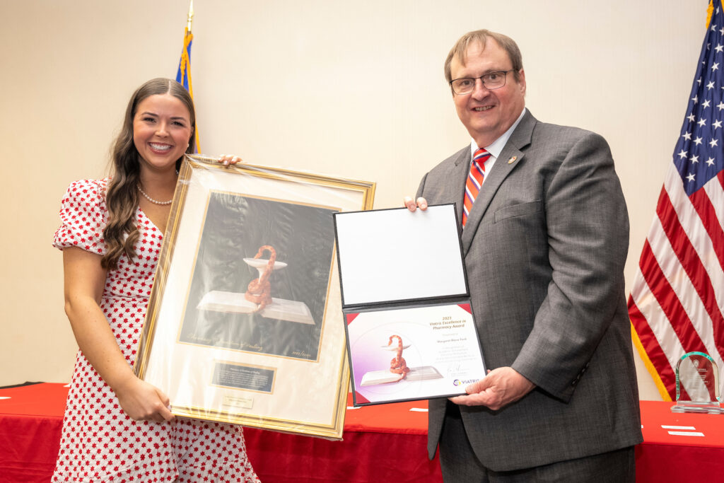 Dean Steve Swanson poses with an award winner.