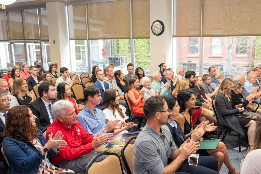 The attendees seated and applauding.