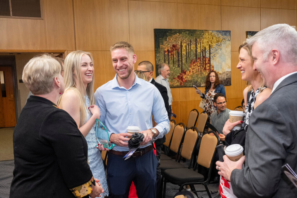 A PharmD graduate speaks with her family.