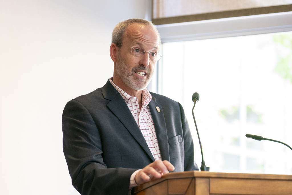 Dave Mott speaks at the podium