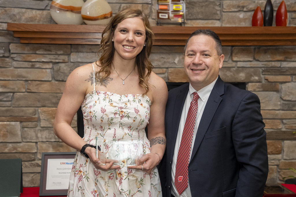 Brent Eberle gives a graduate an award