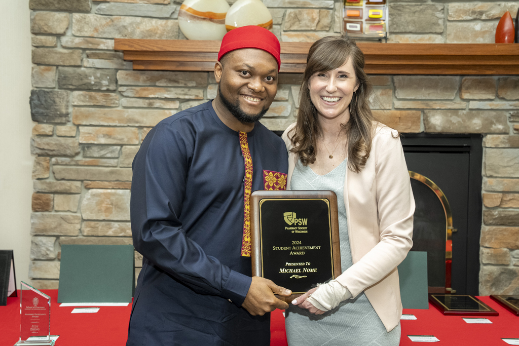 Michael Nome receives an award from Kate Hartkopf