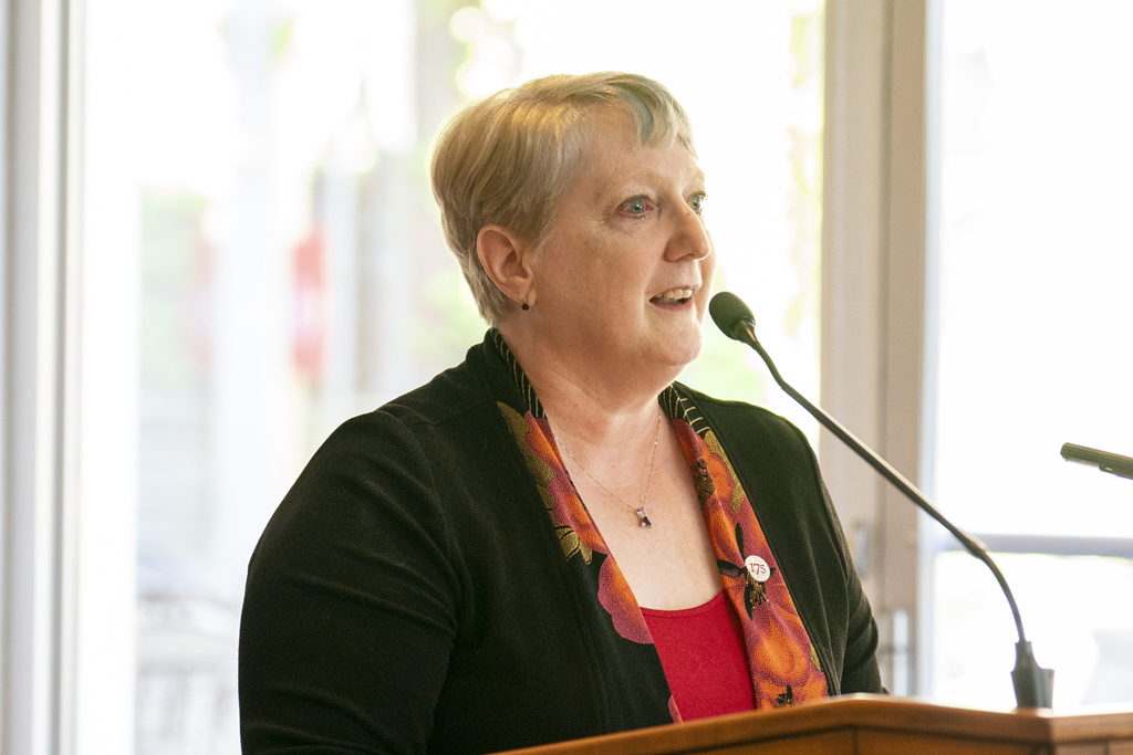 Karen Kopacek speaks at the podium