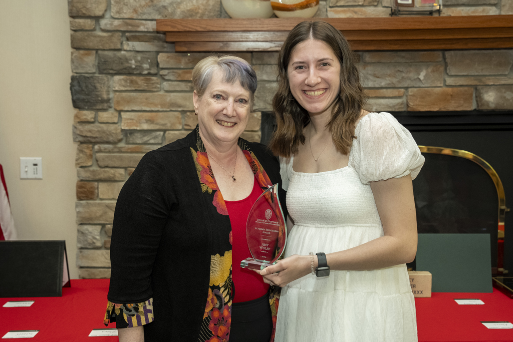 Amy Wolff receives an award from Karen Kopacek