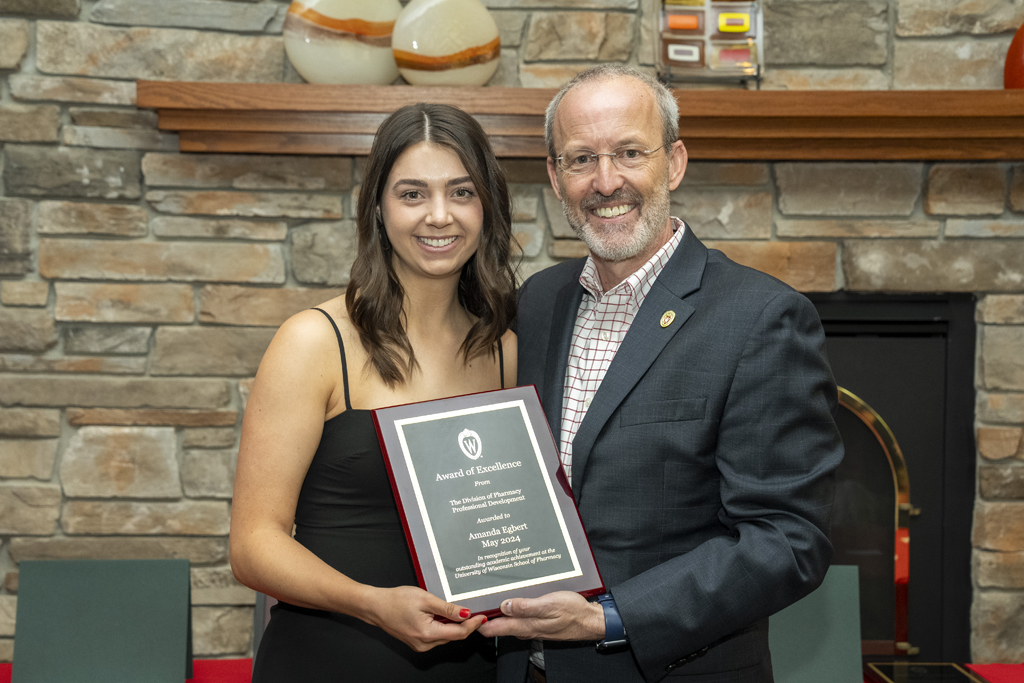 Amanda Egbert receives an award from Dave Mott