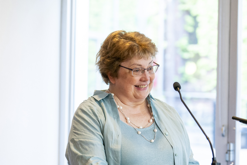 Mary Mably speaks at the podium