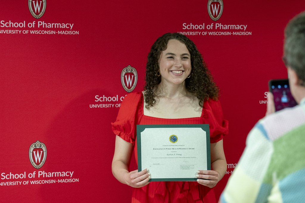 Katie Frietag poses with an award