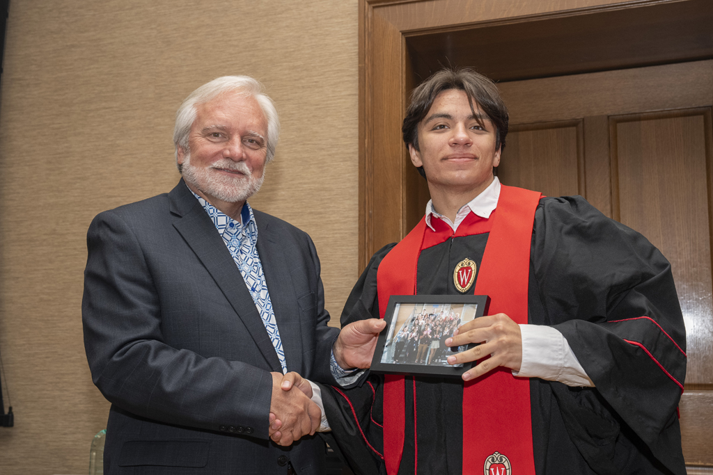 Adam Eckhart accepts a class photo from Jeff Johnson
