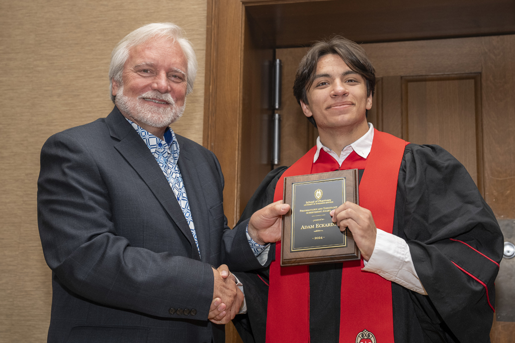 Adam Eckardt receives an award from Jeff Johnson