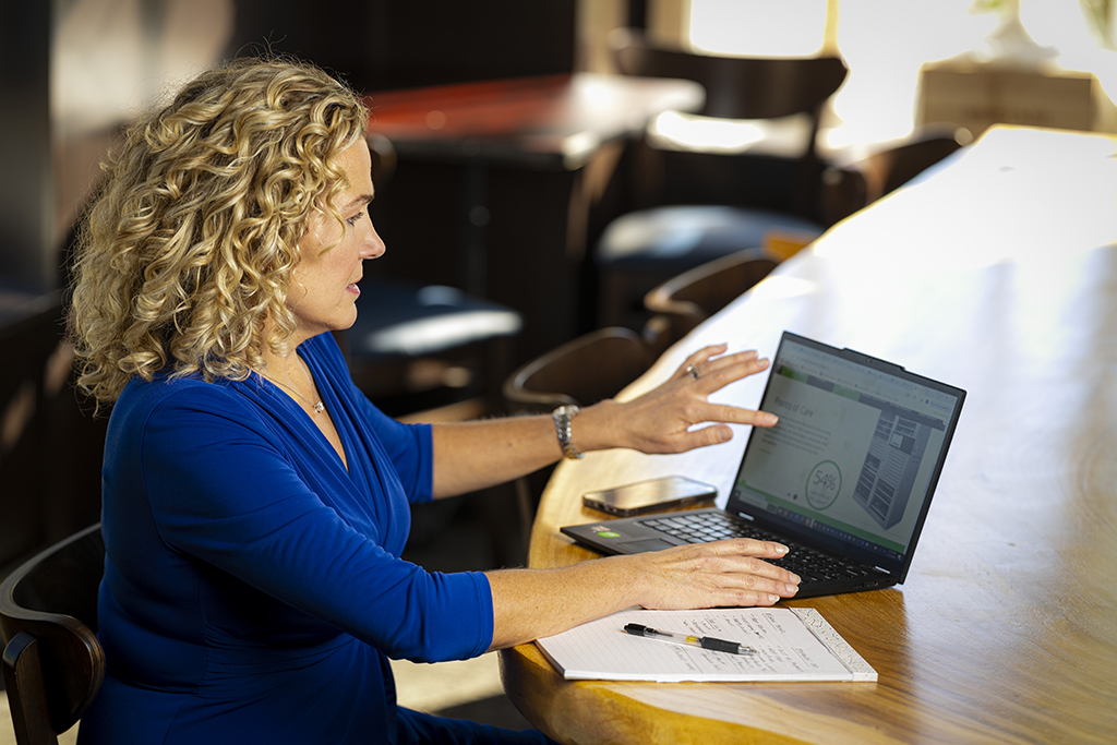 Lani Bertrand works on a laptop, touching the screen.