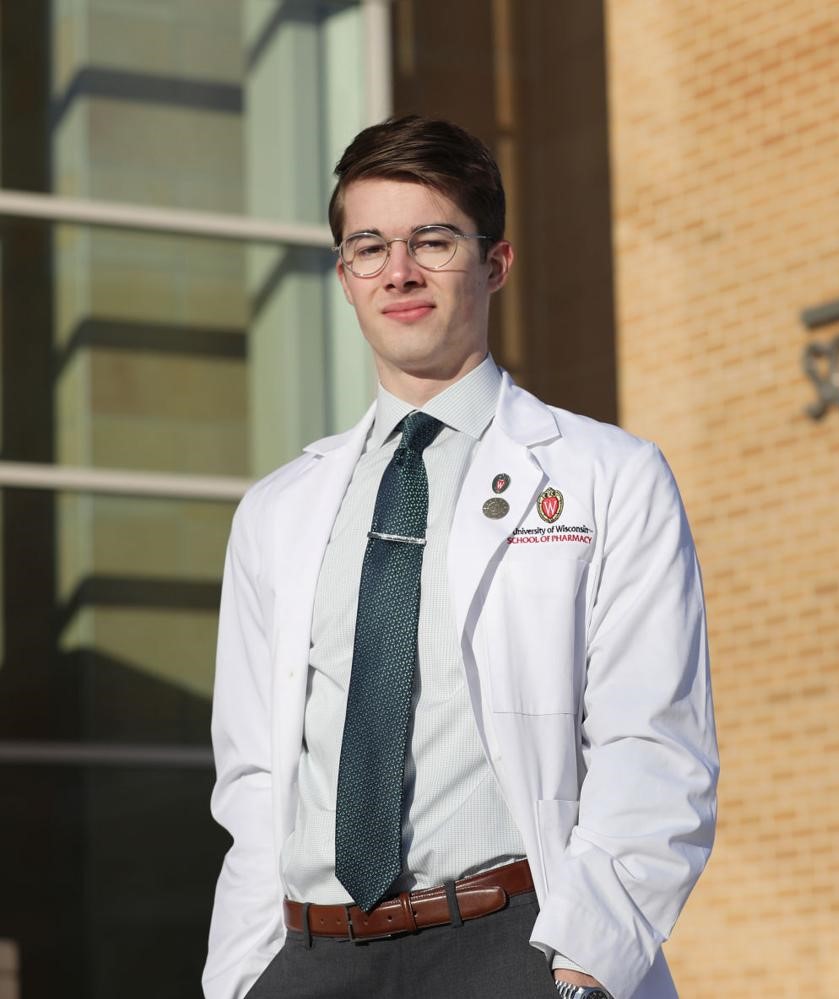 portrait of Alex Peterson wearing School of Pharmacy white coat