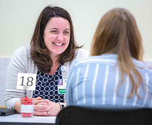 A pharmacy alumni interviews a student