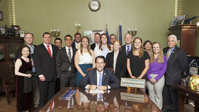 Pharmacy leaders, faculty, and students from the State's pharmacy schools attend the Governor's bill signing ceremony of Act 42 into law.