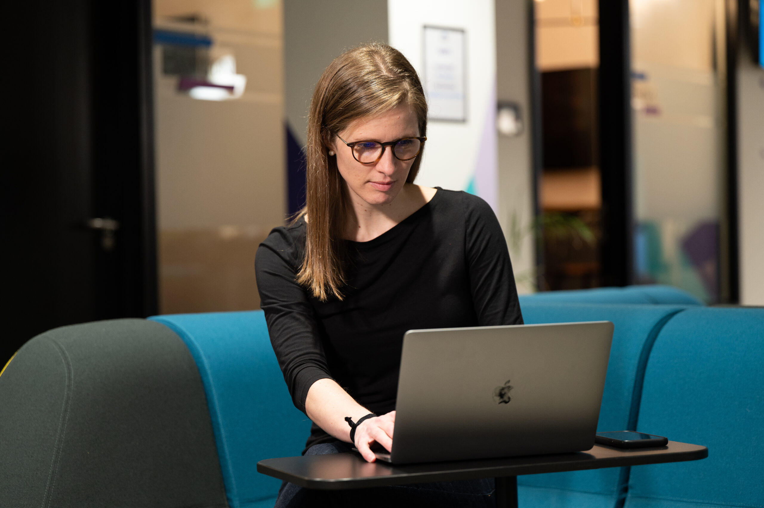 Megan Coder works on her laptop.