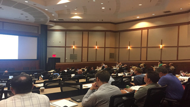 Professionals sitting in lecture hall for conference