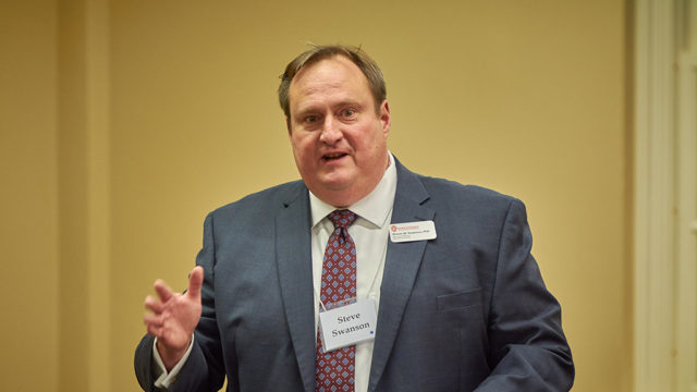 Steve Swanson speaking on-stage