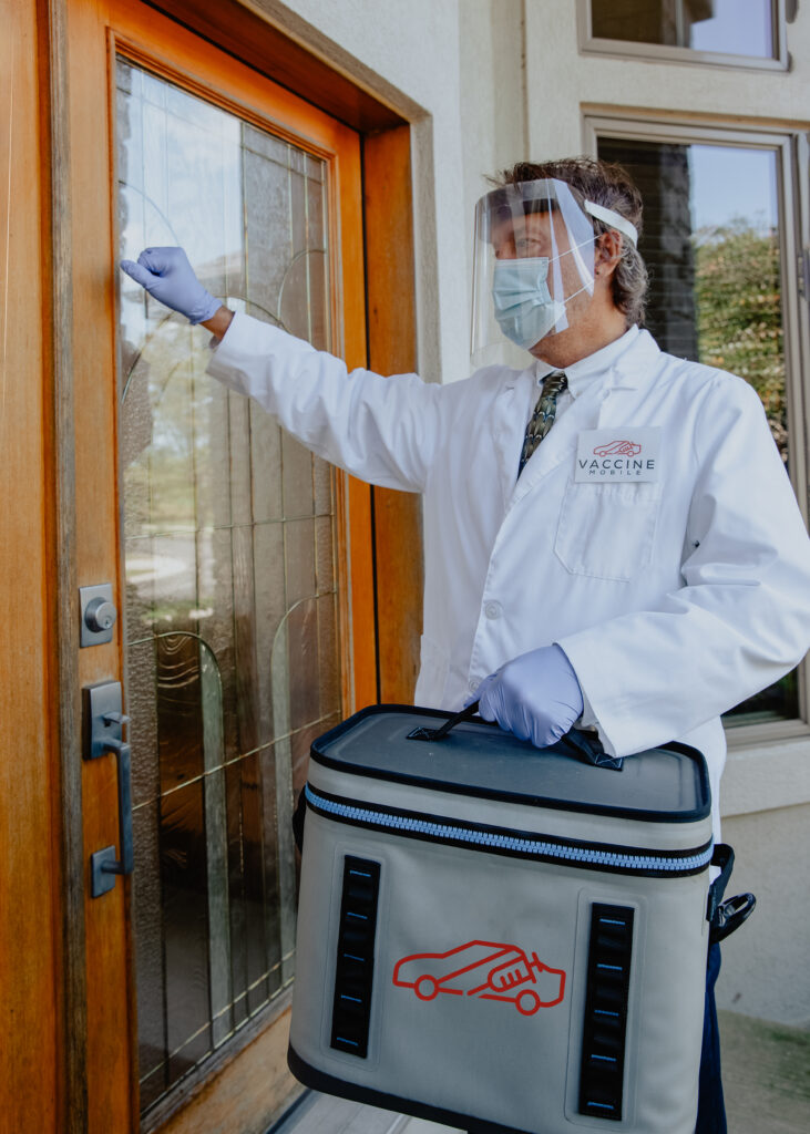 Lance Moran, dressed in PPE, knocking on a patient's door.