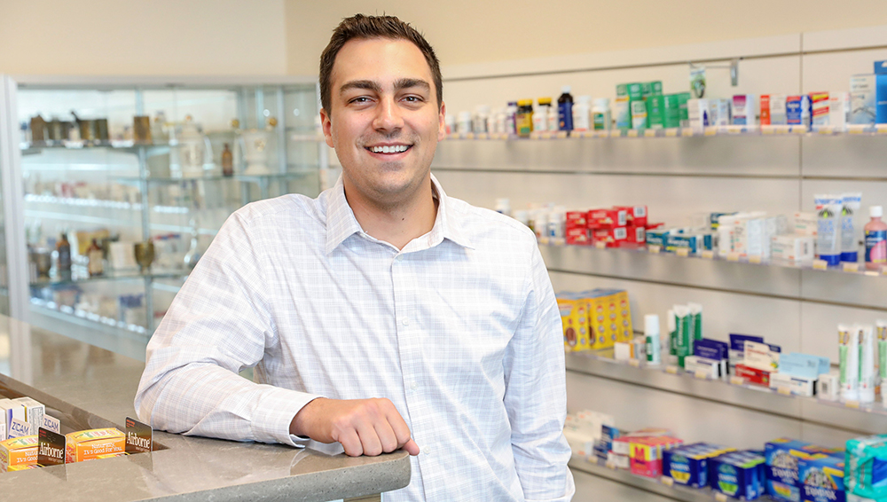 Drew Dretske at a pharmacy counter