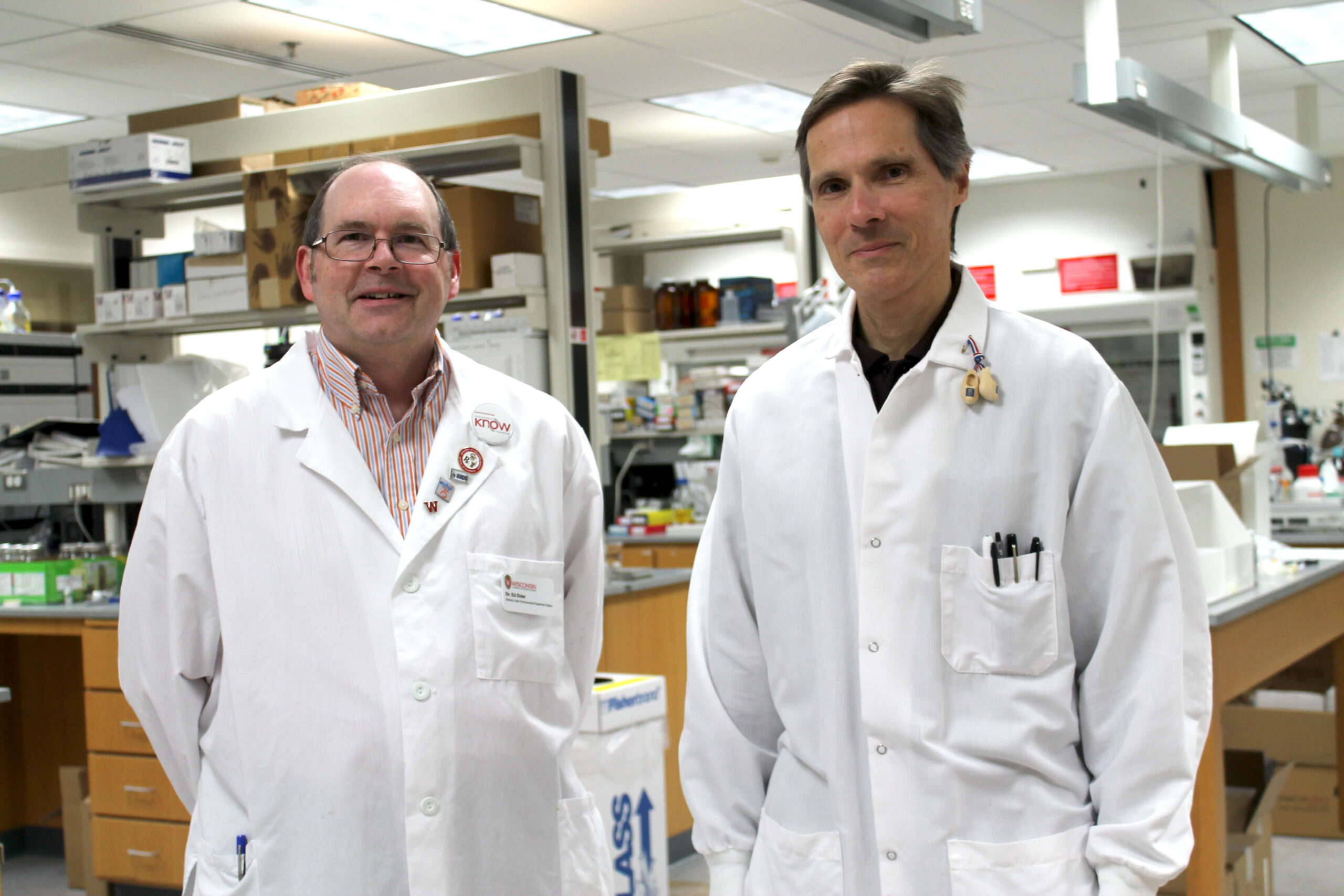 Ed Elder and Mark Sachetti wearing white coats in a lab