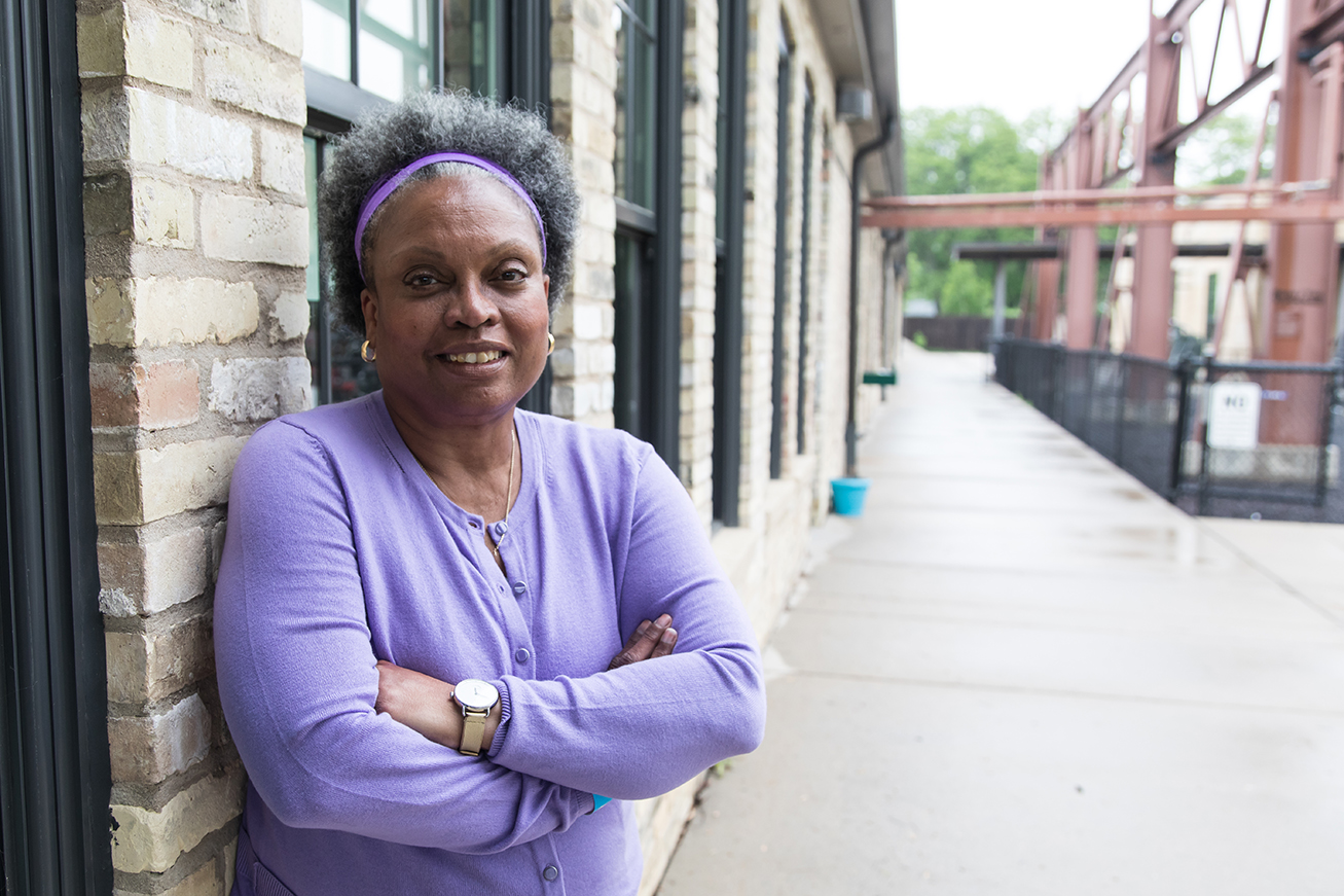 Professor Eva Vivian smiles outside the Goodman Community Center