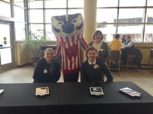 Alex Falk and Connor Crouch at screening table with Bucky Badger