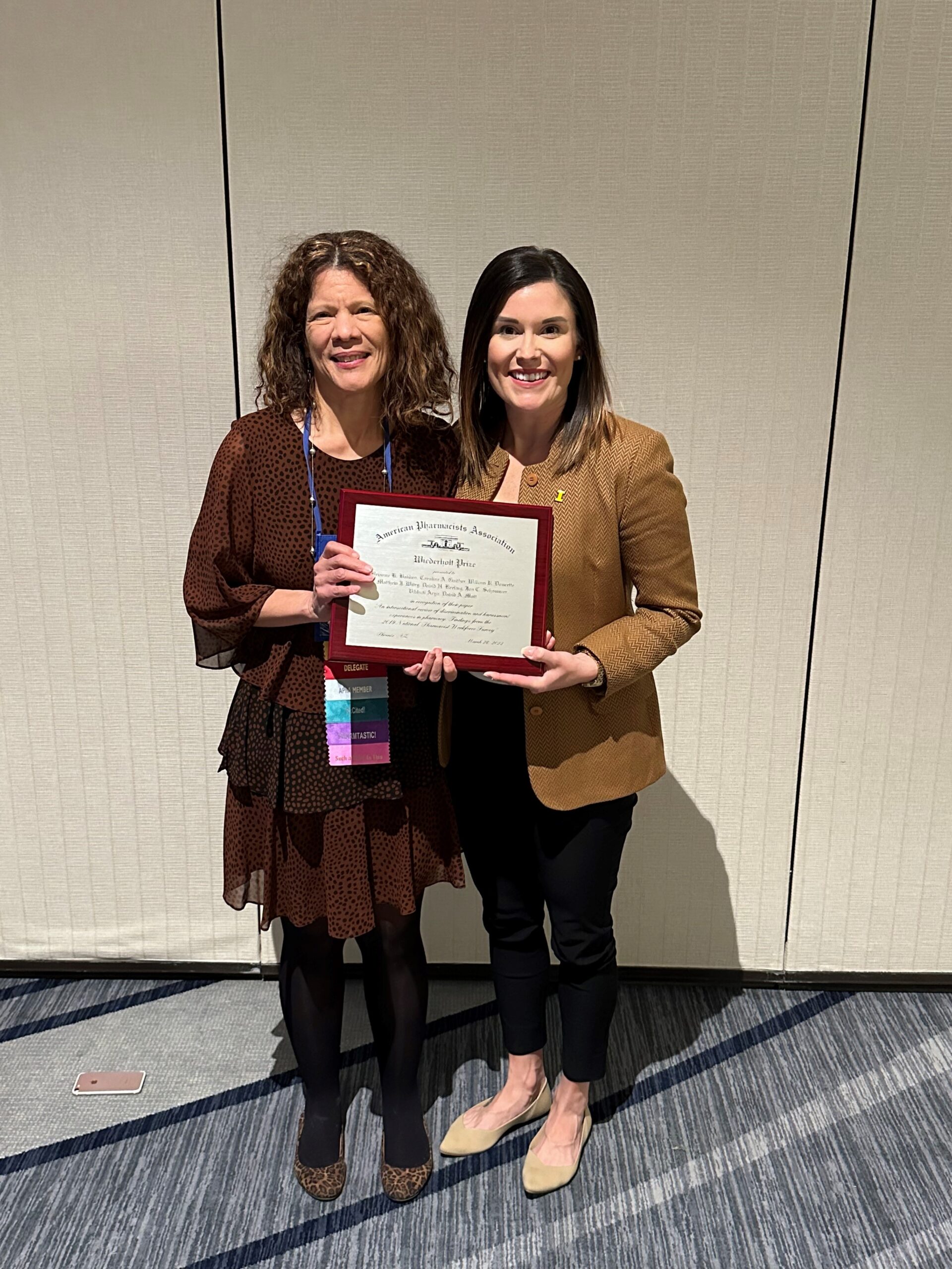 Caroline Gaither and Brianne Bakken holding the Wiederholt Prize