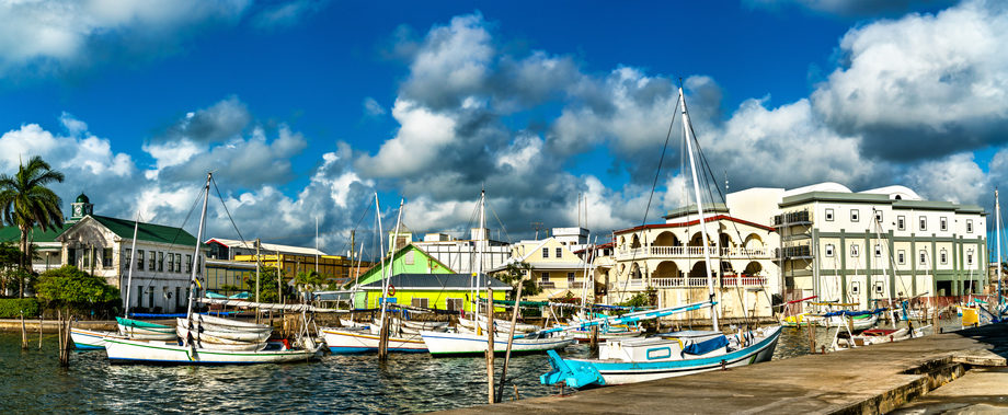 Yachts on the water by houses in Belize City